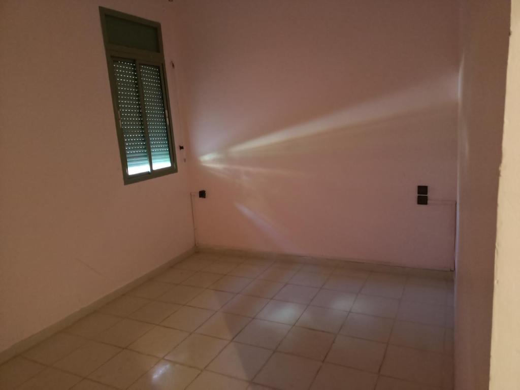an empty room with a window and a tiled floor at Chwiter Marrakech in Chouiter