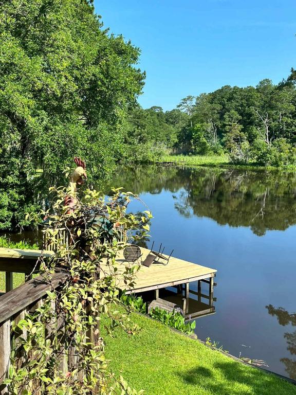 a dock on the side of a lake at Tara's Riverfront Hideaway in Mobile