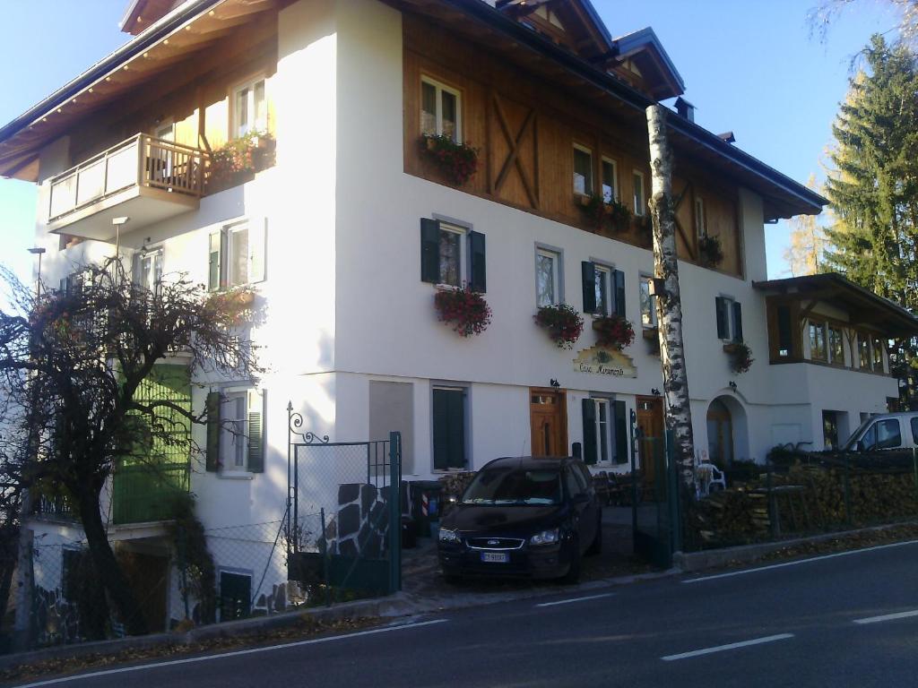 un'auto parcheggiata di fronte a un edificio bianco di Agri-park Casa Miramonte a Ronzone