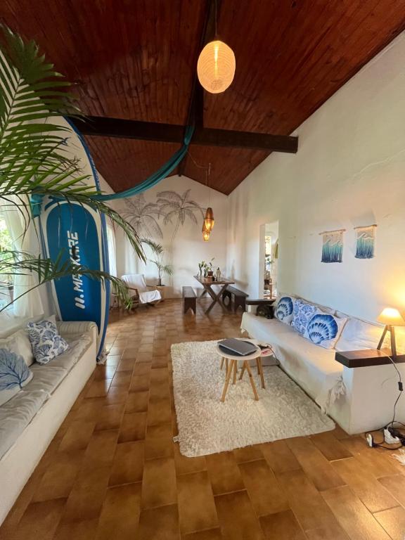 a living room with a couch and a table at Casa Astral Buzios in Búzios
