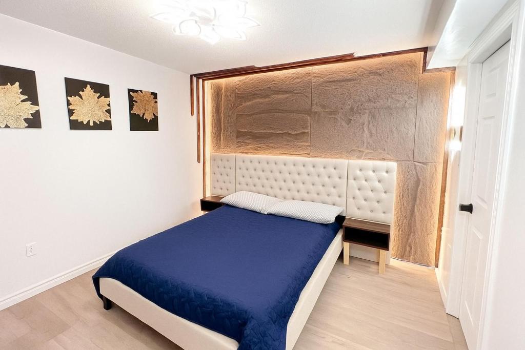 a bedroom with a blue bed and a window at Dar-09 Room Near Airport in Brampton