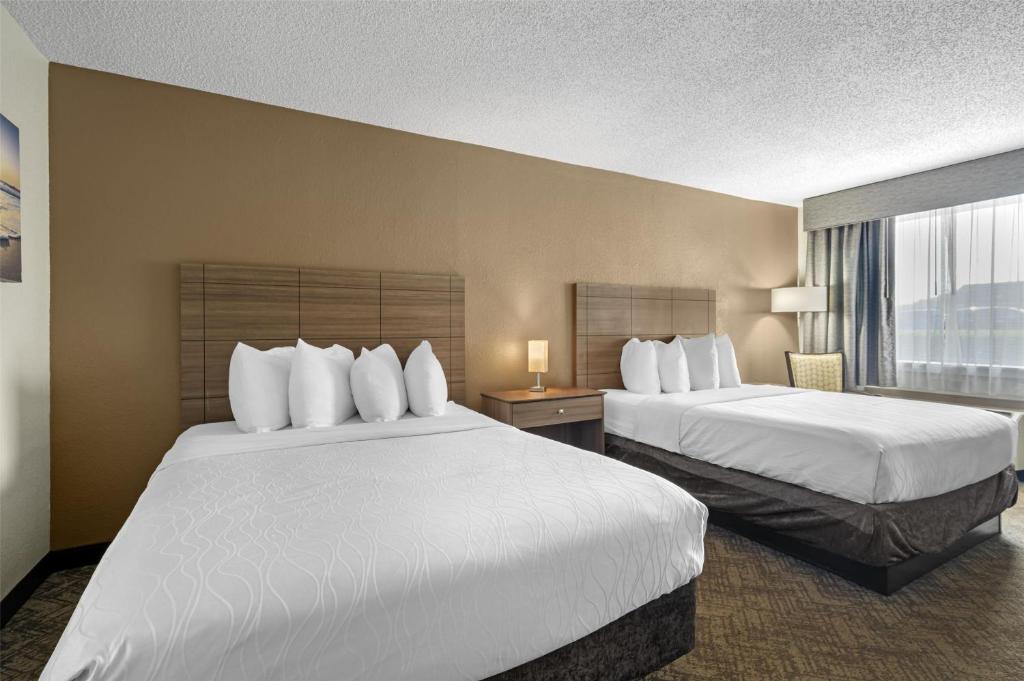 a hotel room with two beds and a window at Best Western Center Inn in Virginia Beach