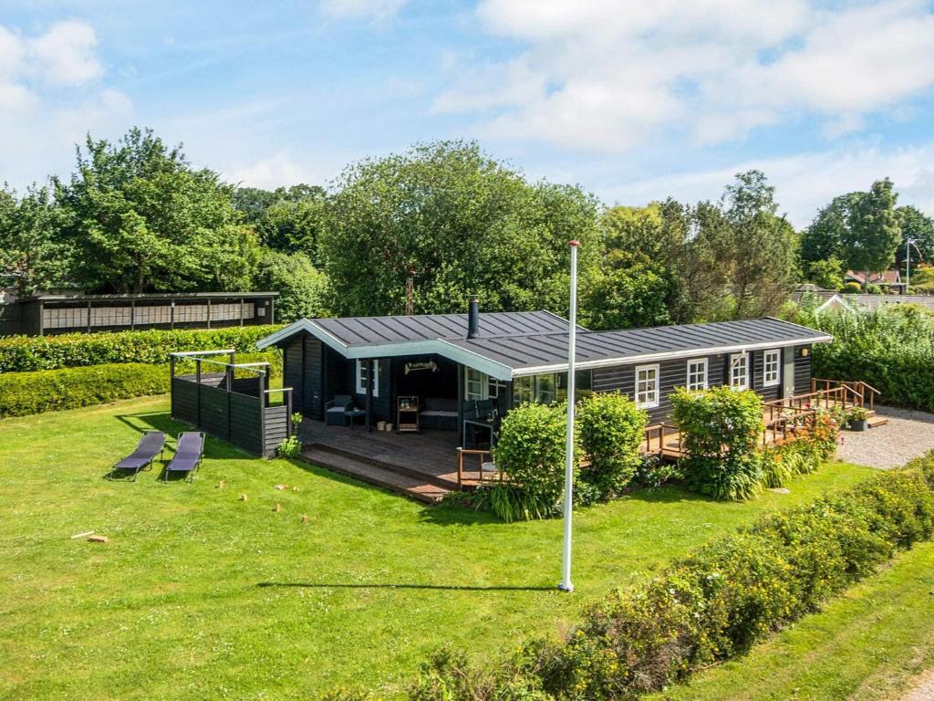 a house with a large yard with a building at 4 star holiday home in Hejls in Hejls