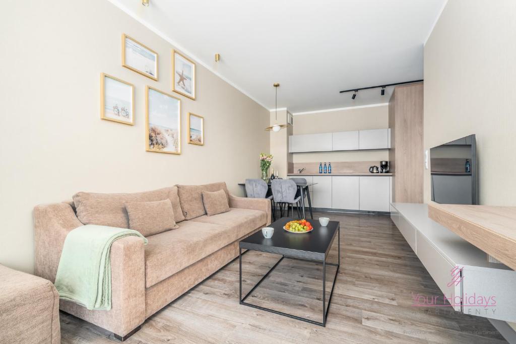 a living room with a couch and a table at Your Holidays Bel Mare Aqua E208 in Międzyzdroje