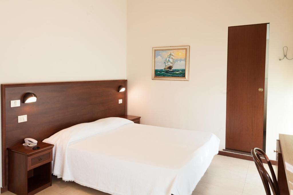 Postel nebo postele na pokoji v ubytování Hotel Metropol