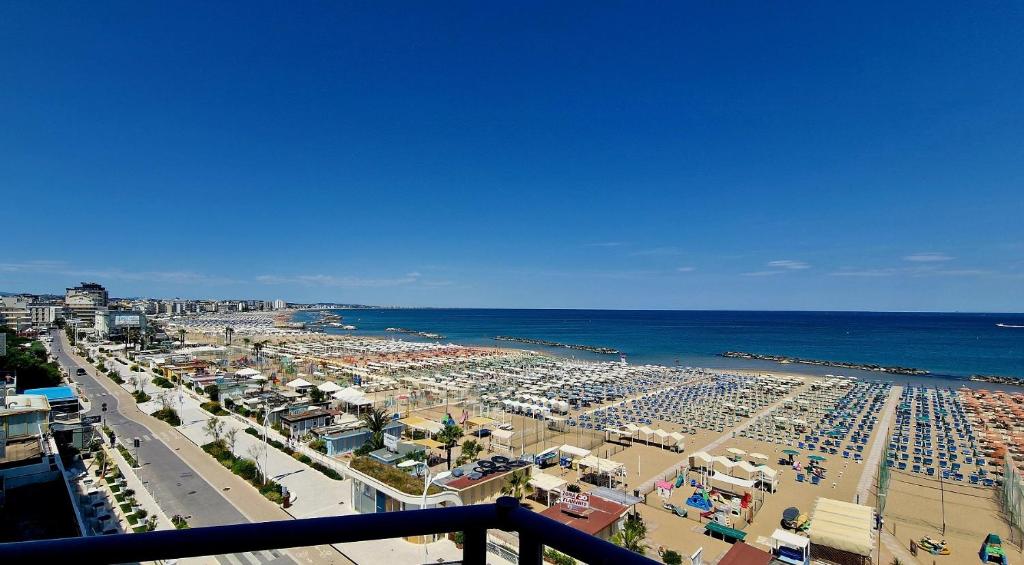 a view of a beach with the ocean and buildings at Hotel Flaminio in Cattolica