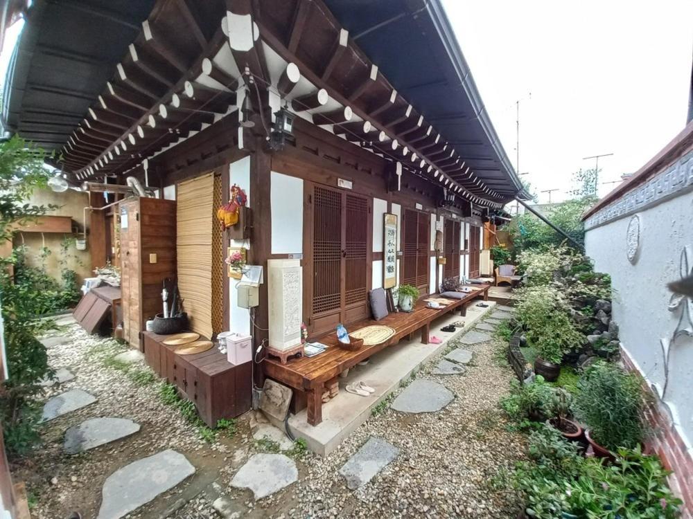 a group of benches sitting outside of a building at Jeonju Sanyacho Pension in Jeonju