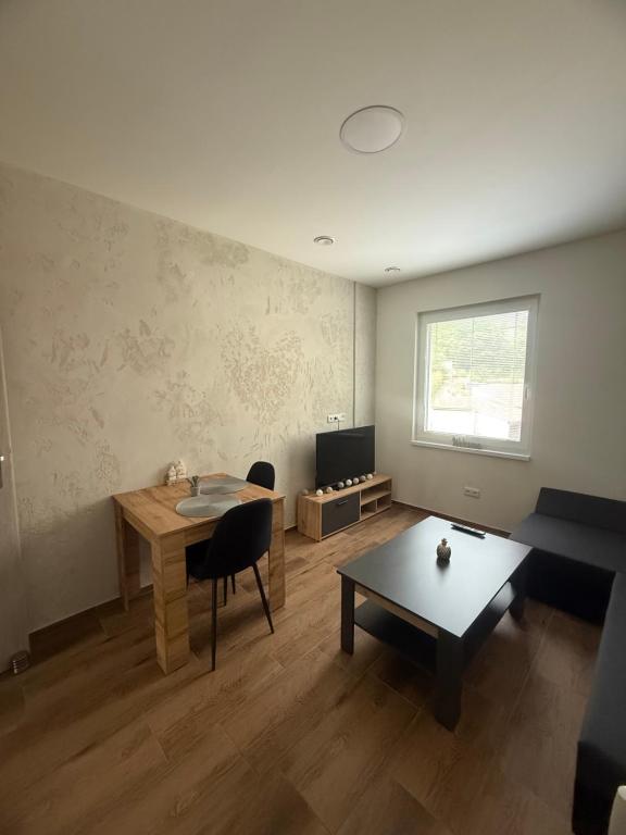 a living room with a table and a couch at Apartmán NIKA Choceň in Choceň