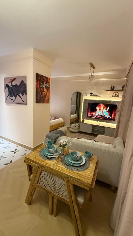 a living room with a table and a fireplace at Chic Retreat Near JKIA and SGR with Nairobi National Park Views in Nairobi