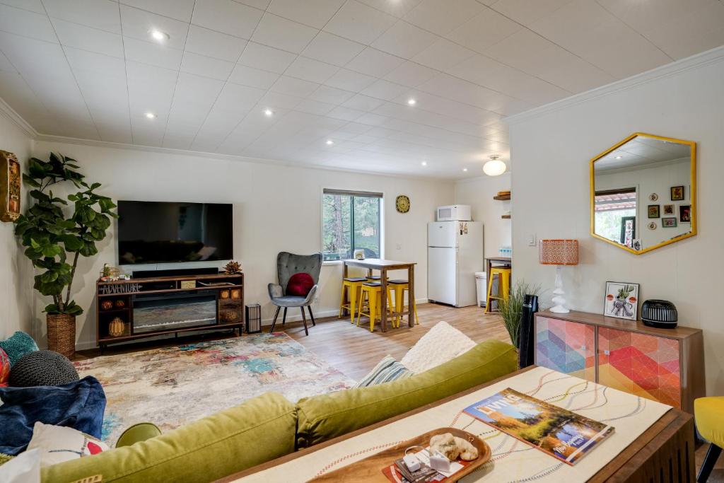 a living room with a couch and a table at 2 Mi to Arizona Christmas City! Cabin with Fireplace in Prescott