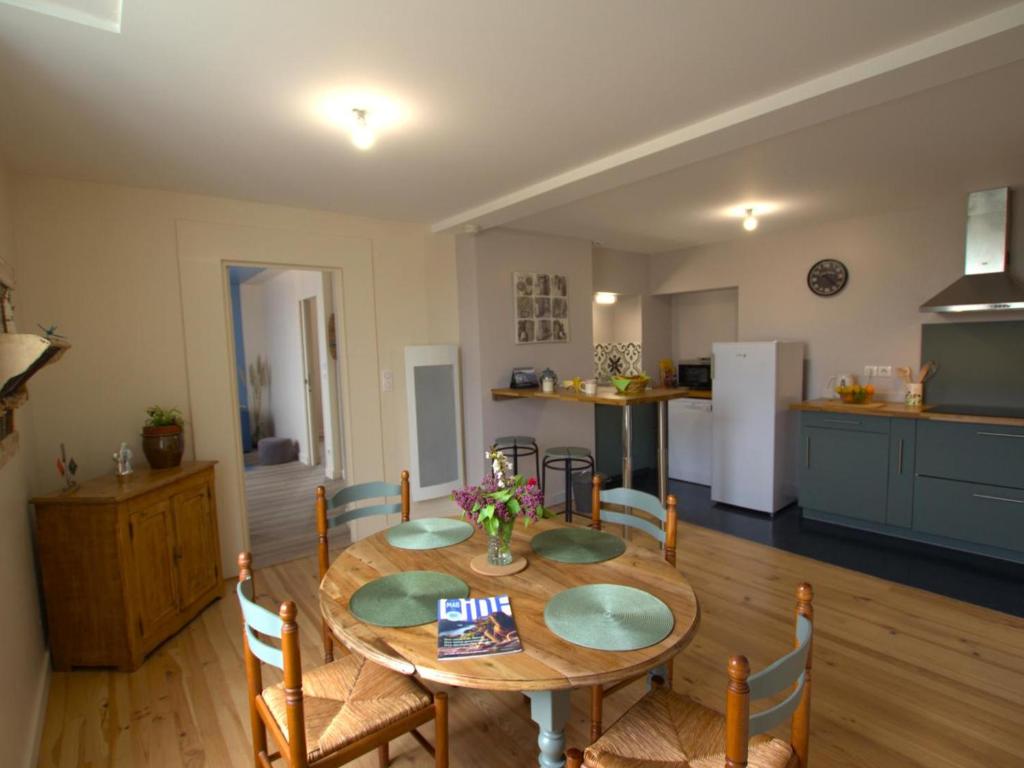 a kitchen and dining room with a table and chairs at Charmant appartement contemporain avec patio cosy et toutes commodités à Chazelles-sur-Lyon - FR-1-496-298 in Chazelles-sur-Lyon
