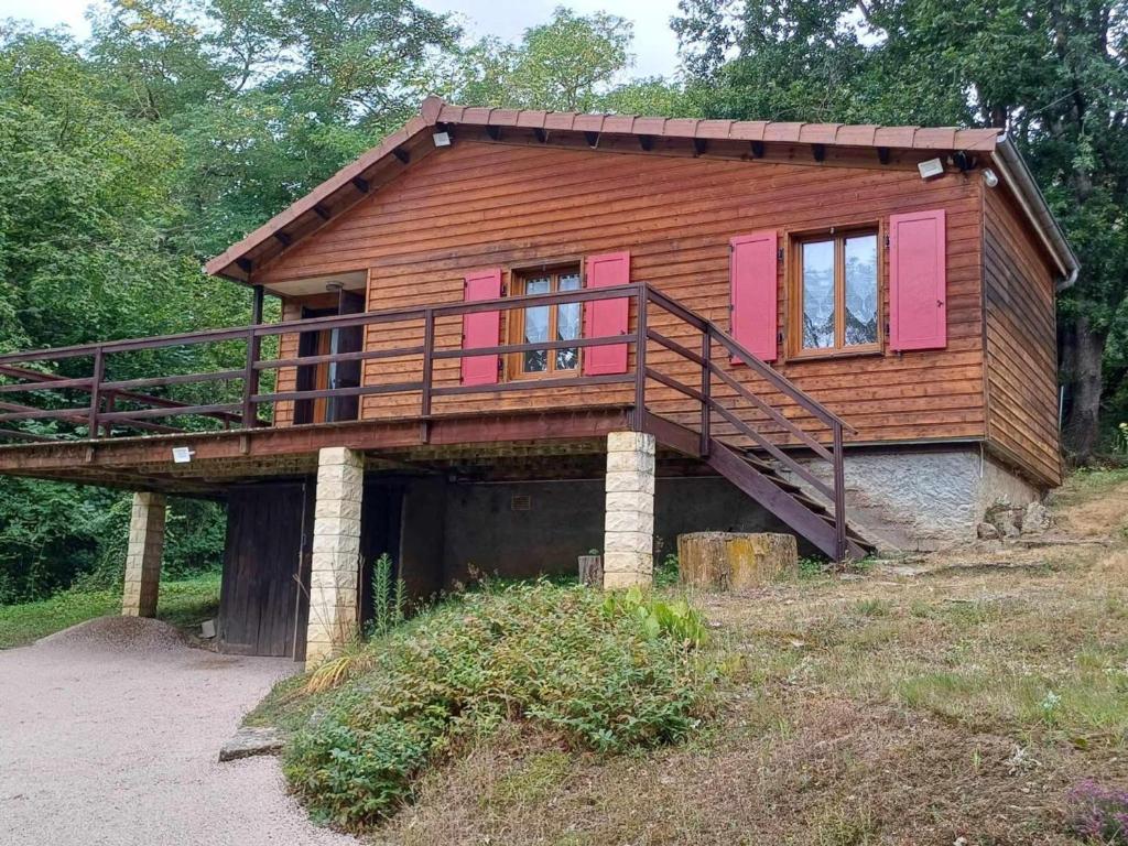 a house with a deck on top of a hill at Chalet paisible avec jardin et wifi à Jenzat - FR-1-489-564 in Jenzat