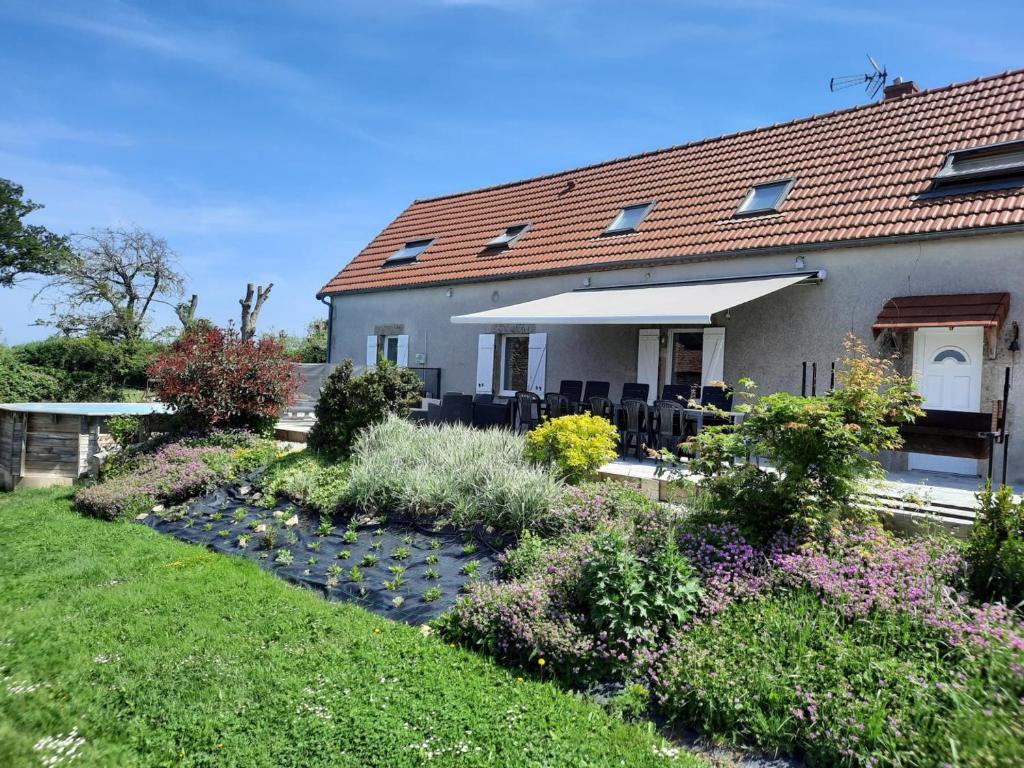 a house with a garden in front of it at Longère rénovée avec piscine privée, Wi-Fi et climatisation - FR-1-489-201 in Échassières
