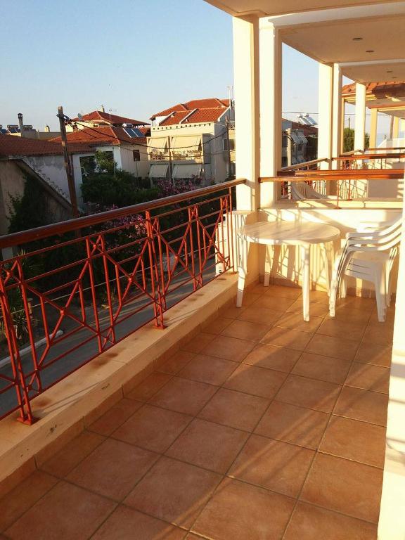a balcony with a table and chairs on a building at Hotel Kosmas in Sarti