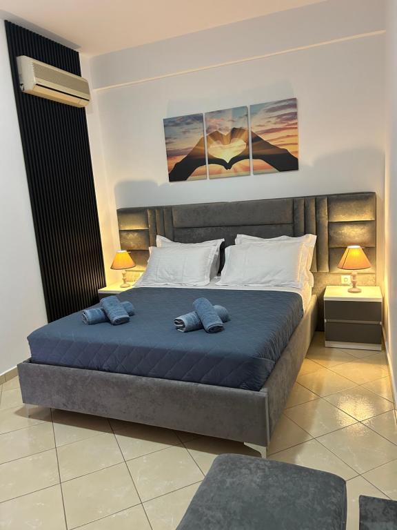a bedroom with a bed with two pillows on it at Ksamil Apartament Sela in Ksamil