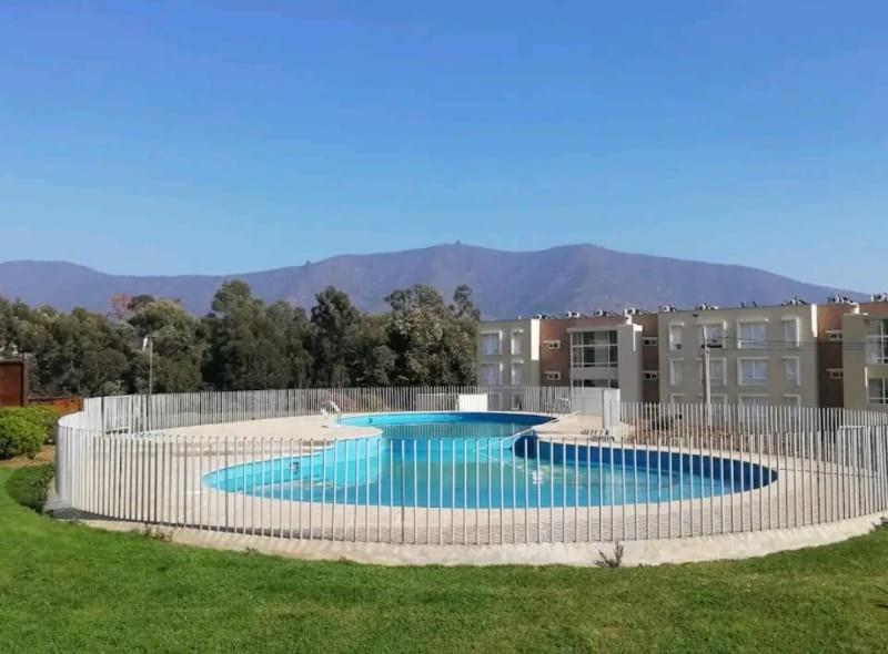 a swimming pool with a fence around it at Lomas de Papudo in Papudo