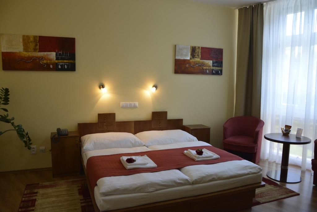 Postel nebo postele na pokoji v ubytování Hotel Banderium