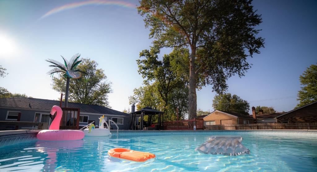 a swimming pool with a pink flamingo and an inflatable at Lush Hideaway with HotTub & Pool 6 mins kings Island in Mason