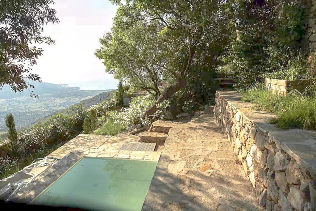 a swimming pool on top of a stone wall at Historic Villa In Sant Antonino With Sea Views in SantʼAntonino