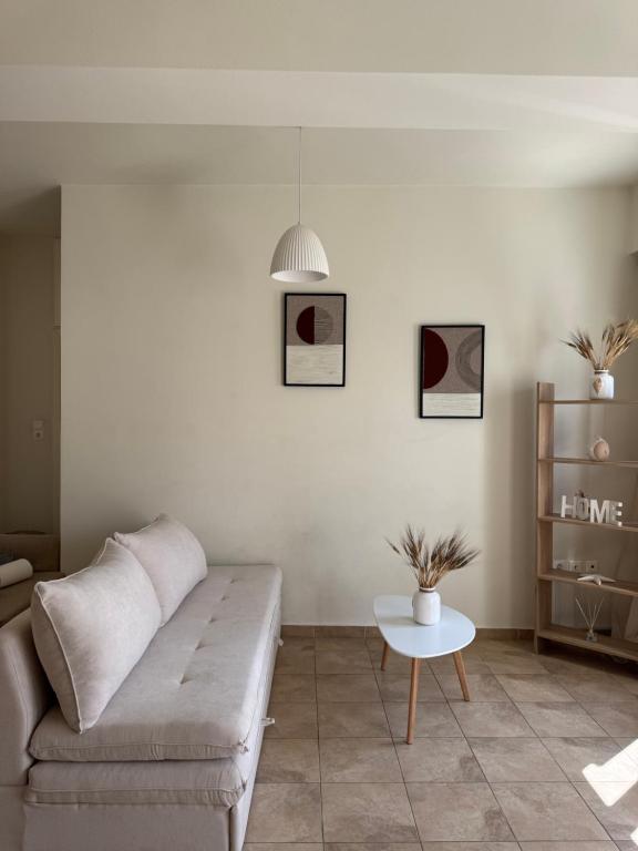 a living room with a couch and a table at Comfy Apartment in Ermoupoli
