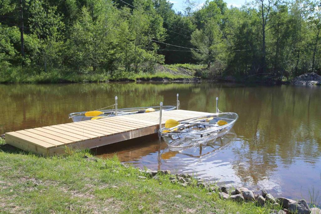 a boat parked next to a dock on a lake at Cozy Cottage House - Pool & Hot Tub in Ferndale