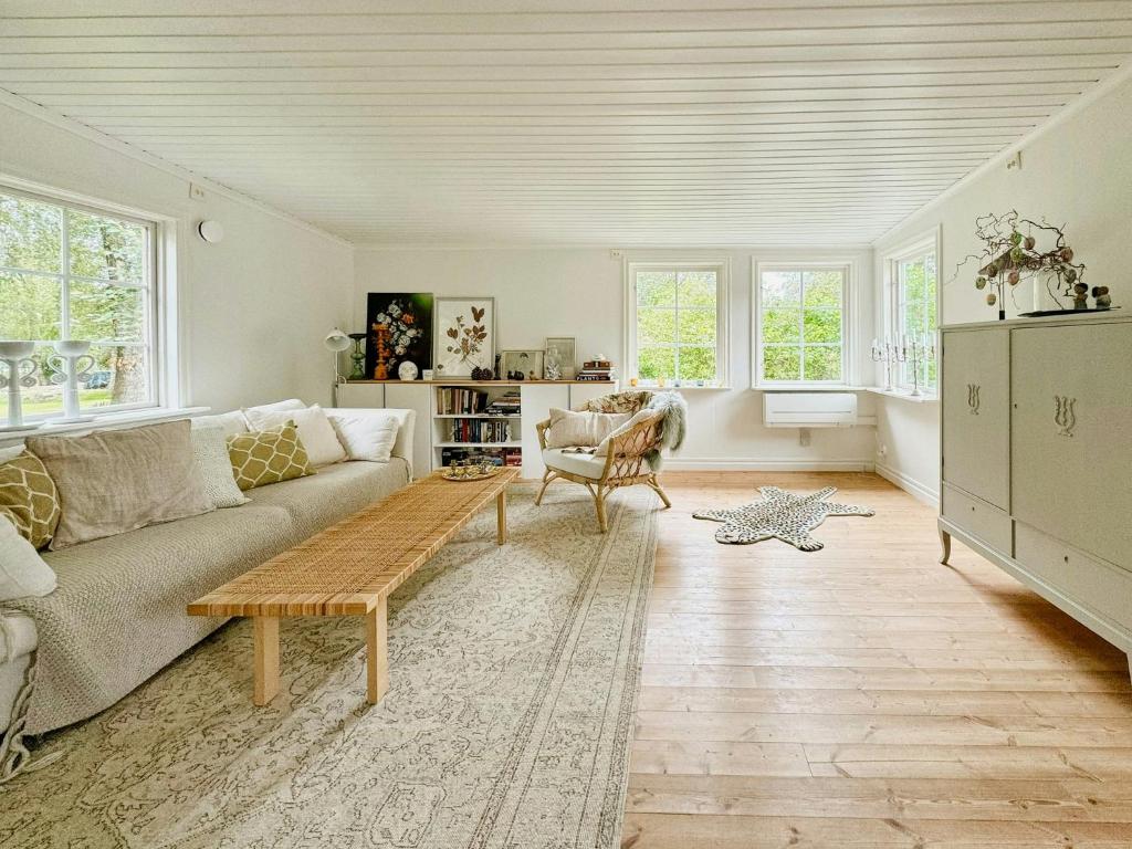 a living room with a couch and a coffee table at Cozy Spacious Cottage By Water And Nature in Brastad