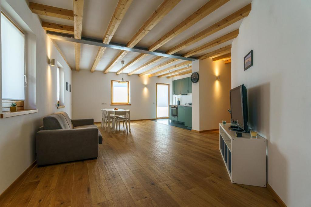 a living room with a couch and a tv at Casa Corradini by Go New Location in Carano