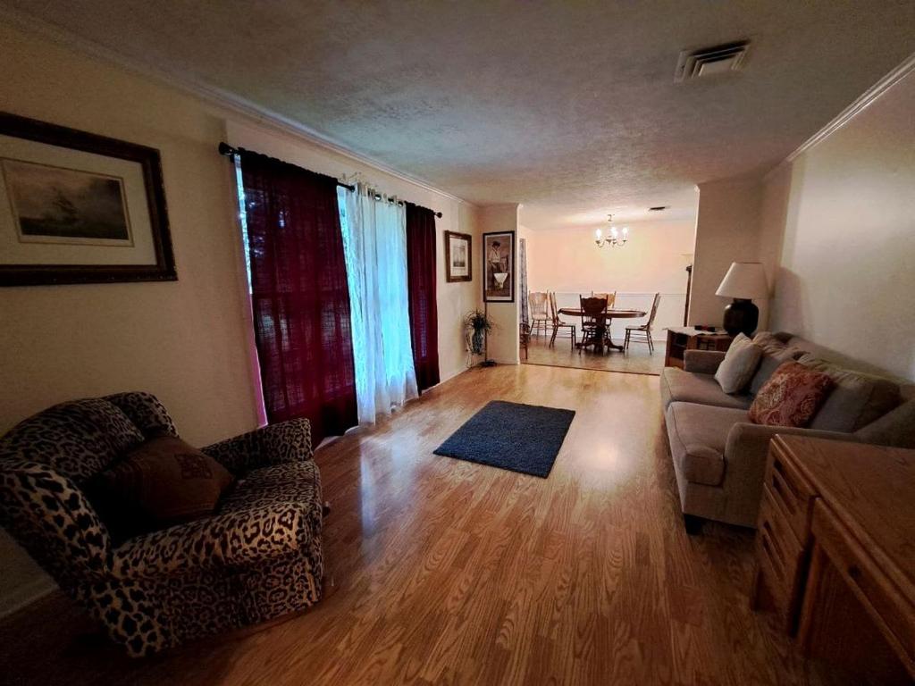 a living room with a couch and chairs and a table at Pet-Friendly 3-Bedroom Ranch with Backyard, Fireplace & Near Nashville in Mount Juliet