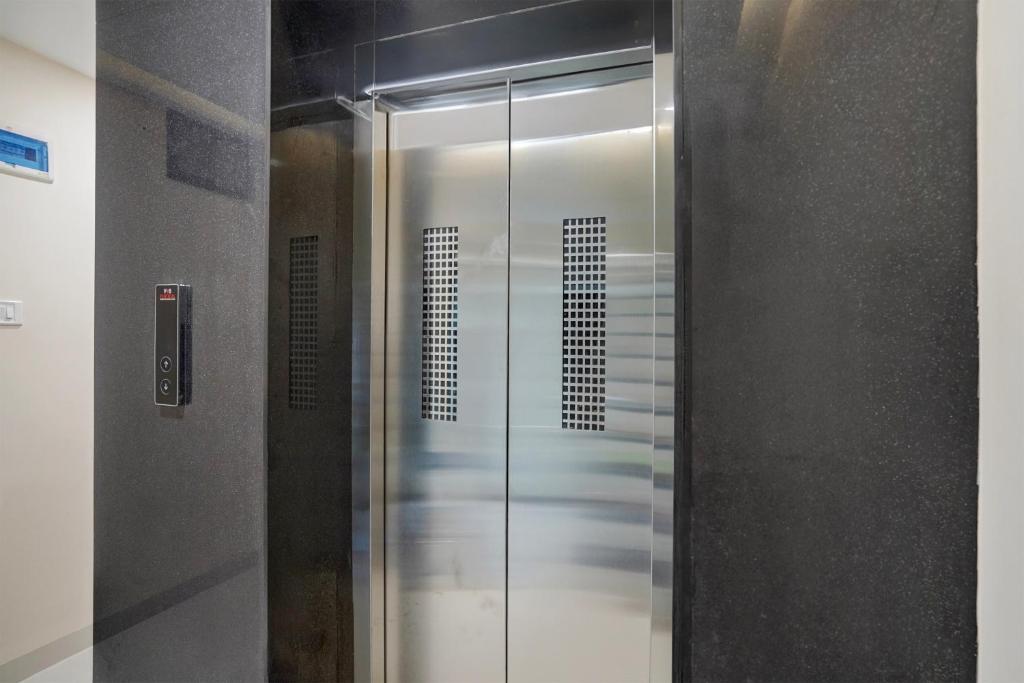 a shower with a glass door in a bathroom at Hotel O Lakshya in Indore