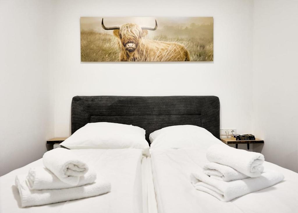 a bed with a picture of a bull with horns at Northside I - Evergreen in Cuxhaven