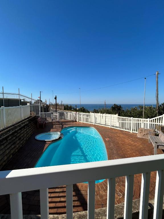 a swimming pool on the balcony of a house at Coastal Bliss Retreat Peacehaven - Pool and Braai - 2 Adults 2 Children in Scottburgh