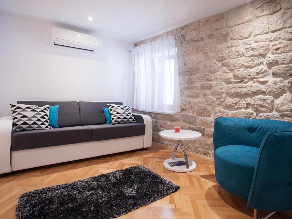 a living room with a couch and a table at Apartment Heart of Trogir in Trogir