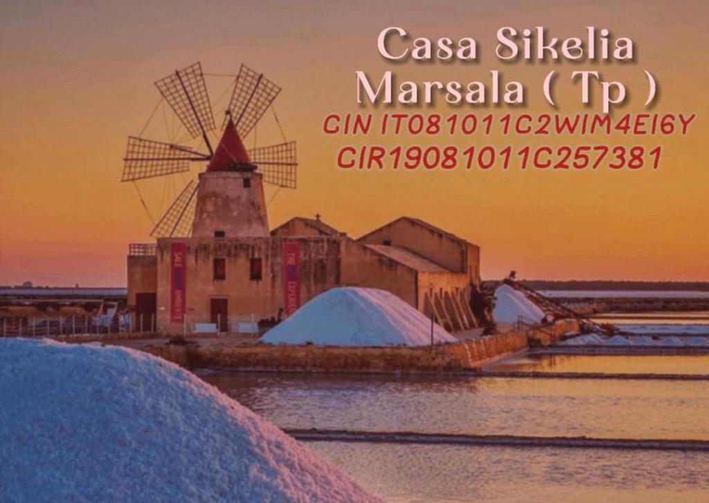 a picture of a windmill with snow in the foreground at Casa Sikelia in Marsala