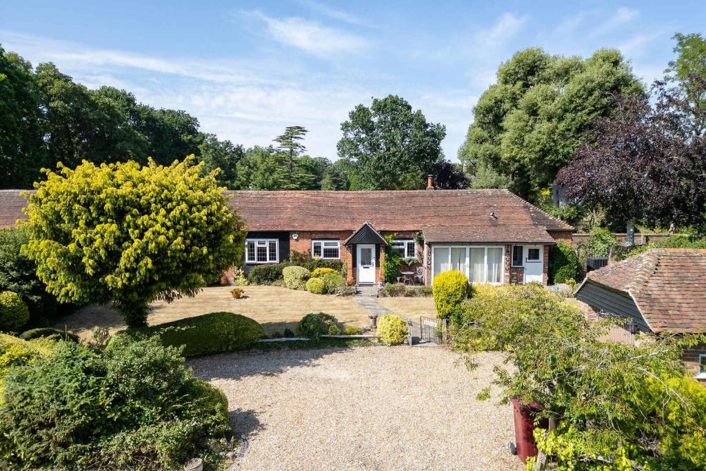 a house with a garden in front of it at Homely Cottage for 6 Near Chichester & Goodwood in Chichester