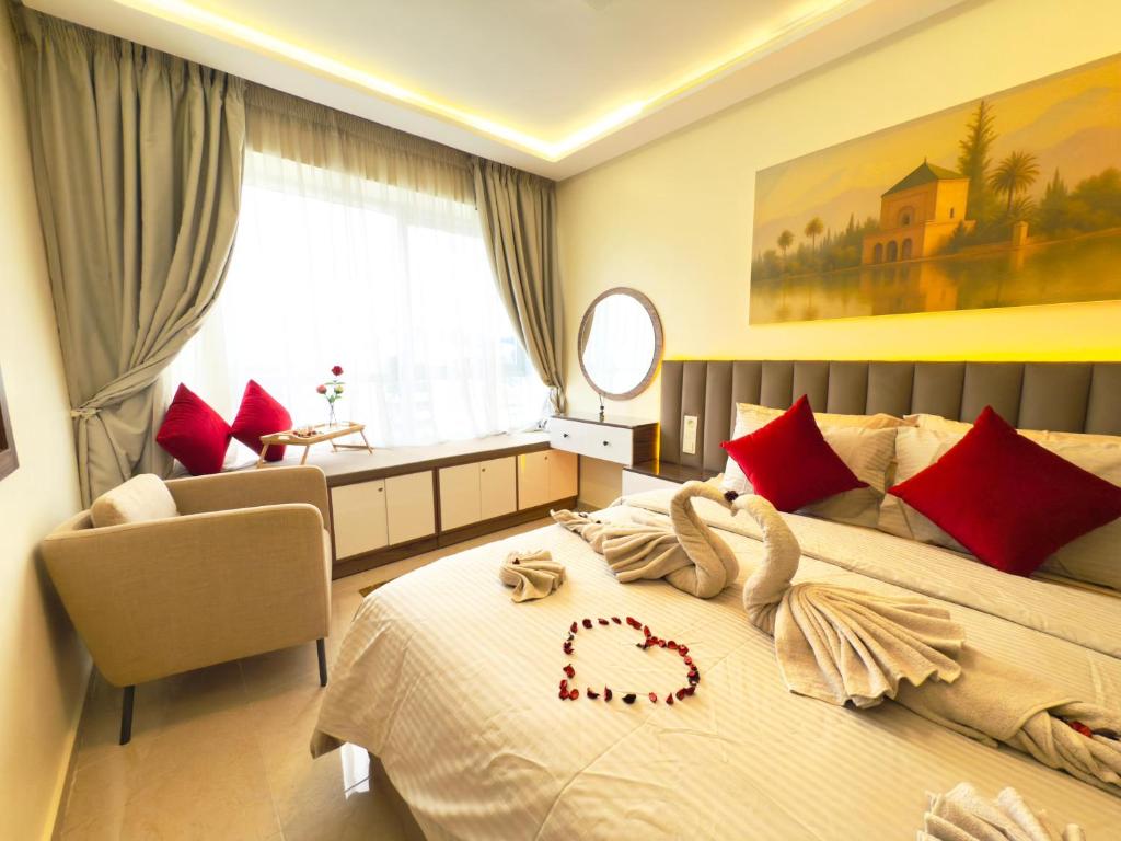 a bedroom with a large bed with red pillows at Cosy Nest - Home cinema, Beach, Mall, TGV station, IPTV, WIFI, AC in Tangier