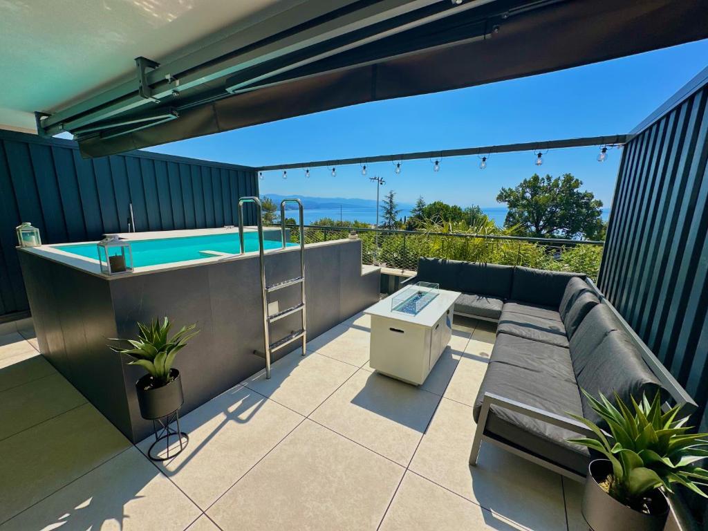 a patio with a hot tub and a table at Boutique Spa Studioapartment IV in Opatija