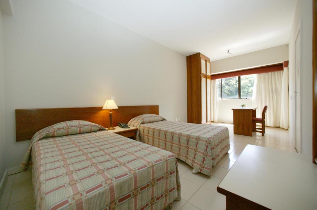 Postel nebo postele na pokoji v ubytování Residencial Porto Farol