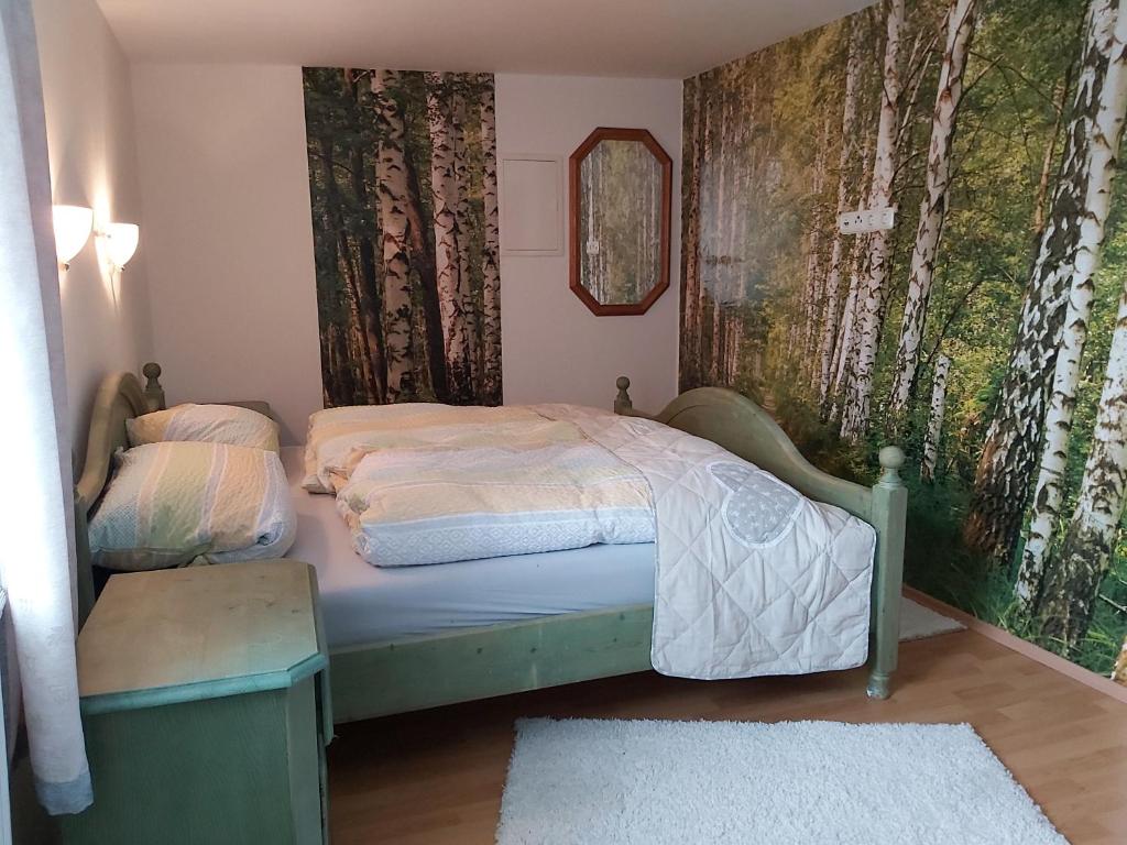 a small bedroom with a bed and a mirror at Anno Wohlfühlidylle in Kirchdorf im Wald