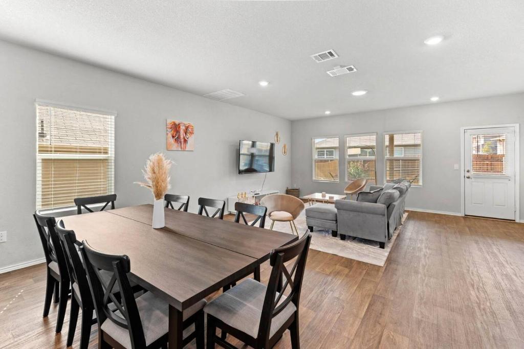 a dining room and living room with a table and chairs at Luxury Spacious GameRoom Sleeps 15 people in Austin