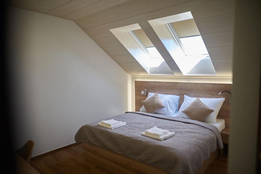 a bedroom with a bed with two towels on it at Penzion 666 Slavonice in Slavonice