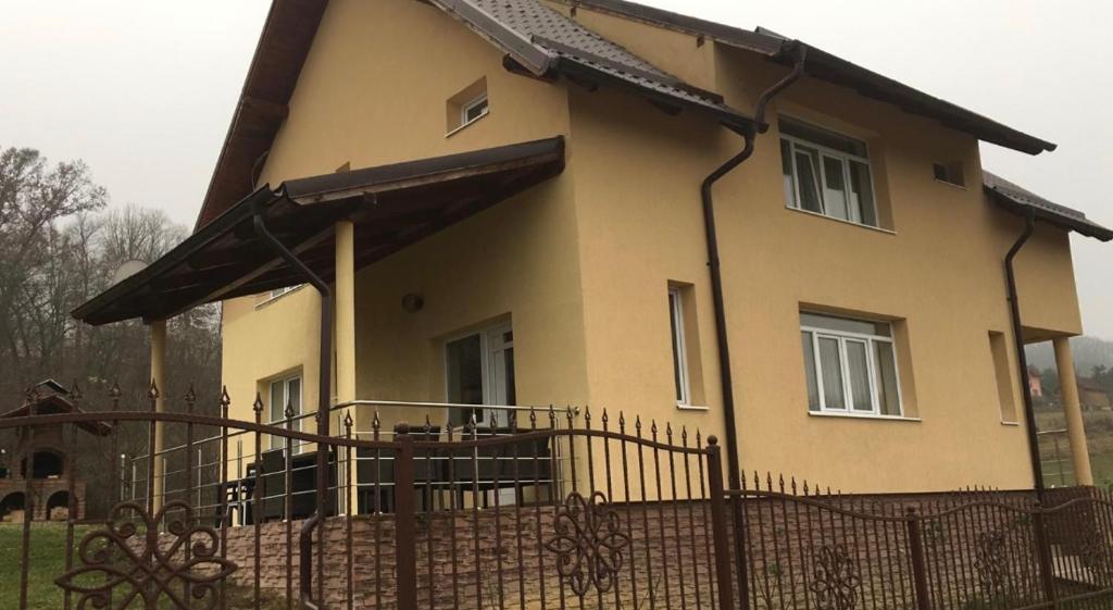 a house with a fence in front of it at Vila Costea in Geoagiu Băi