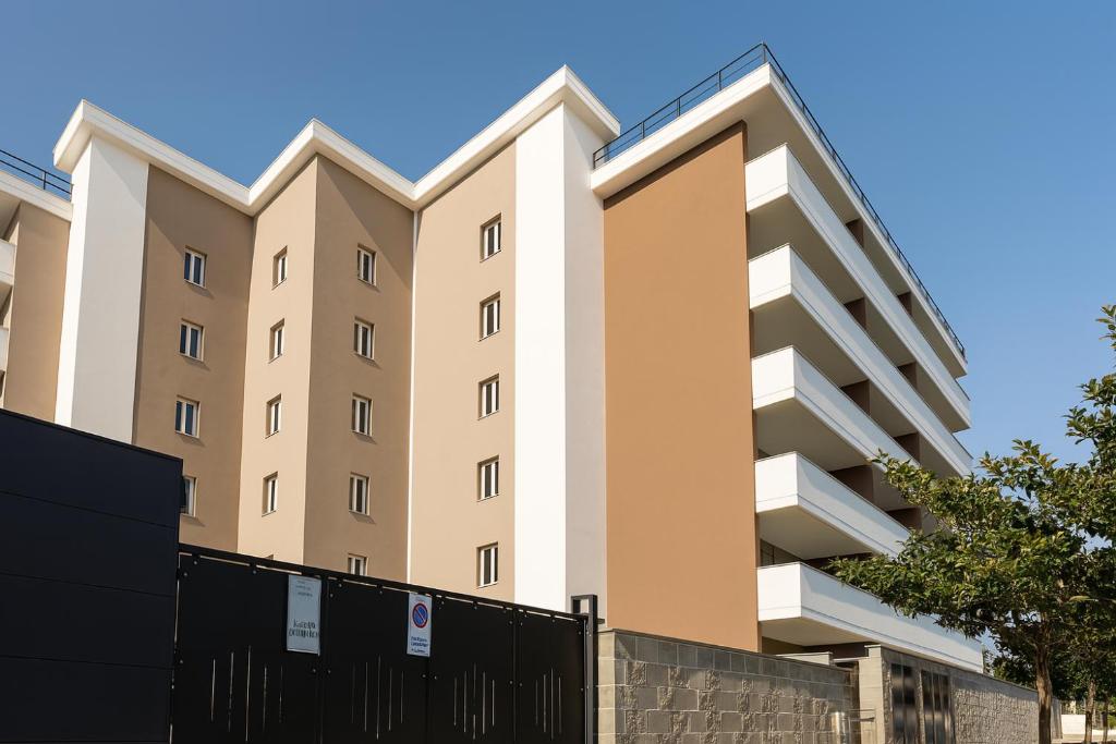 an apartment building with a fence in front of it at Mirti Suite Roma in Rome