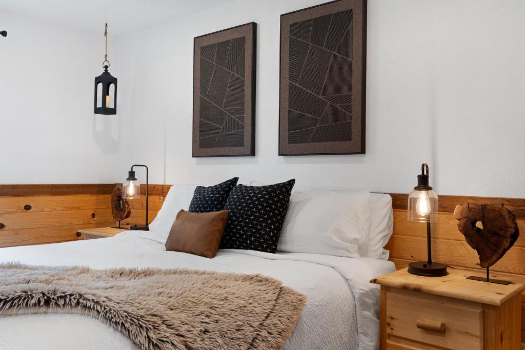 a bedroom with a bed with pillows on it at Trails End Cabin with a hot tub fire pit & indoor pool in Bryant