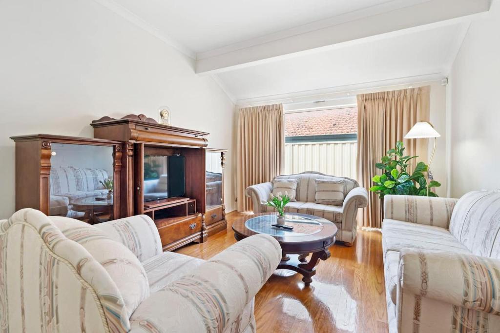 a living room with two white couches and a table at Winthrop Mansion - 5 Bed, 3 Bath, Pool Table, Bbq in Perth