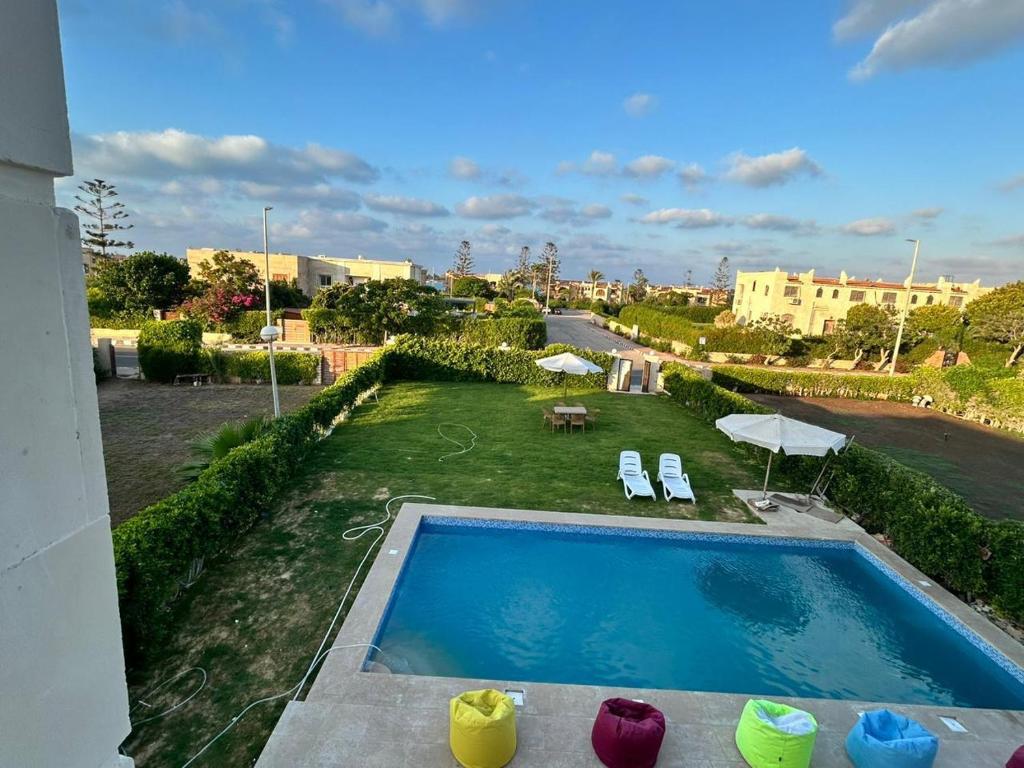 a view of a swimming pool from a building at فرصة نادرة فيلا مستقلة بحمام سباحة خاص in El Alamein