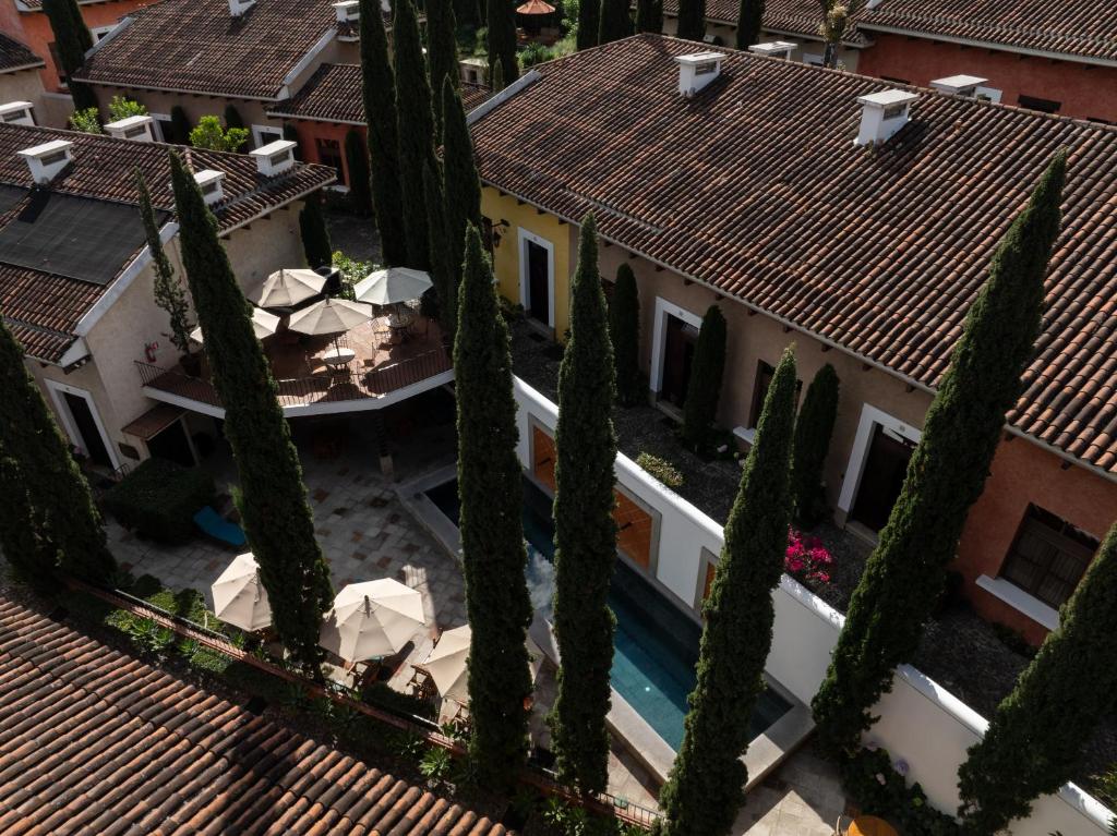 an overhead view of a building with cypress trees at La Villa de que buscabas en Antigua Guatemala in Antigua Guatemala