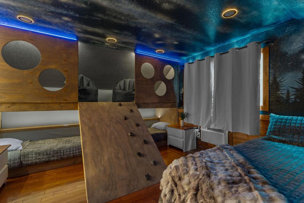 a bedroom with a room with a bed and a room with a moon and stars at Wood Haven Cabin with a hot tub fire pit & indoor pool in Bryant