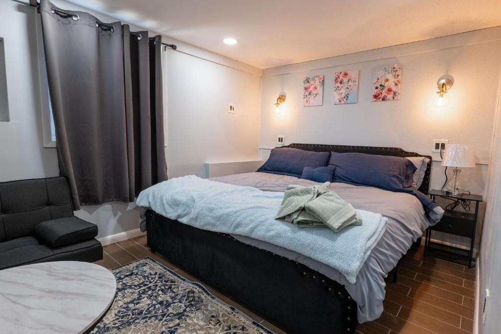 a bedroom with a large bed and a chair at Studio Apt Lake Park Station Airport Hospital NJ NYC in Rahway