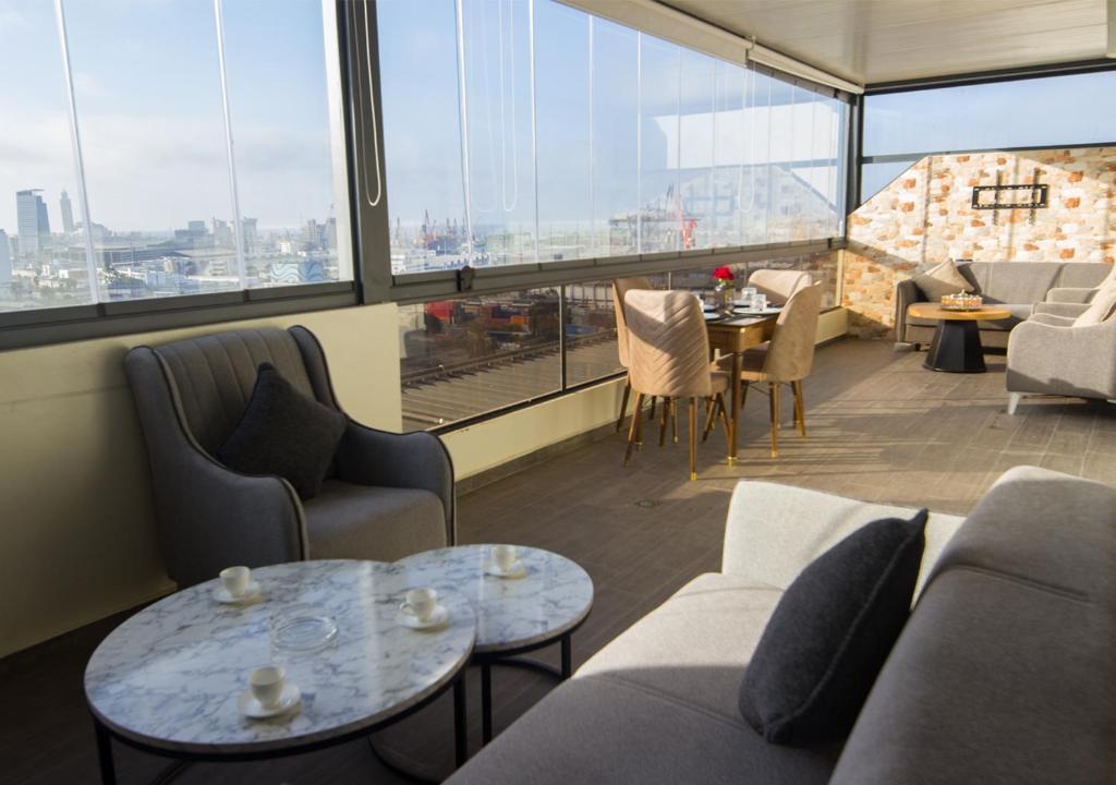 a living room with couches and tables and windows at R102-3-4 Amazing apartments in Belvedere with Breathtaking Ocean and Street Views in Casablanca