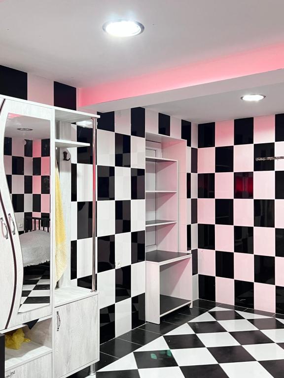 a room with black and white checkered wall at Hotel Egrisi in Senaki in Senaki